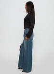 side view of model wearing Princess Polly Laguardia Wide Leg Jeans Dark Blue Wash Mid Rise 