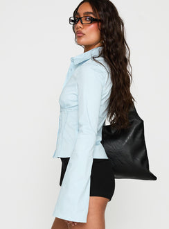 side view of model wearing Princess Polly Merritt Top Blue Full Sleeves V-Neck 