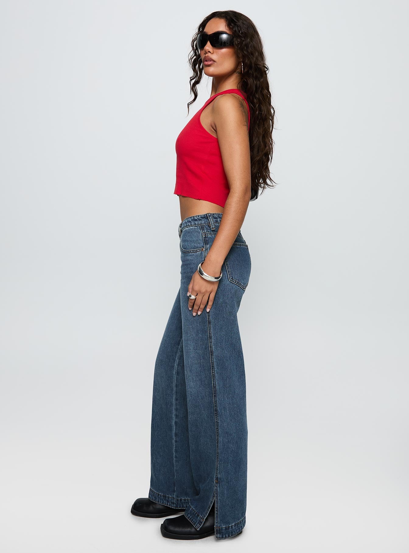 side view of model wearing Princess Polly Dog Days Mid Rise Straight Leg Jeans Dark Blue Wash Mid Rise Jeans 