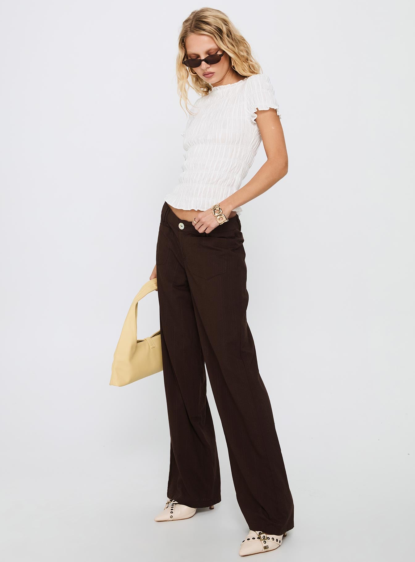 side view of model wearing Princess Polly Vendi Low Rise Pant Chocolate Low Rise Pants 