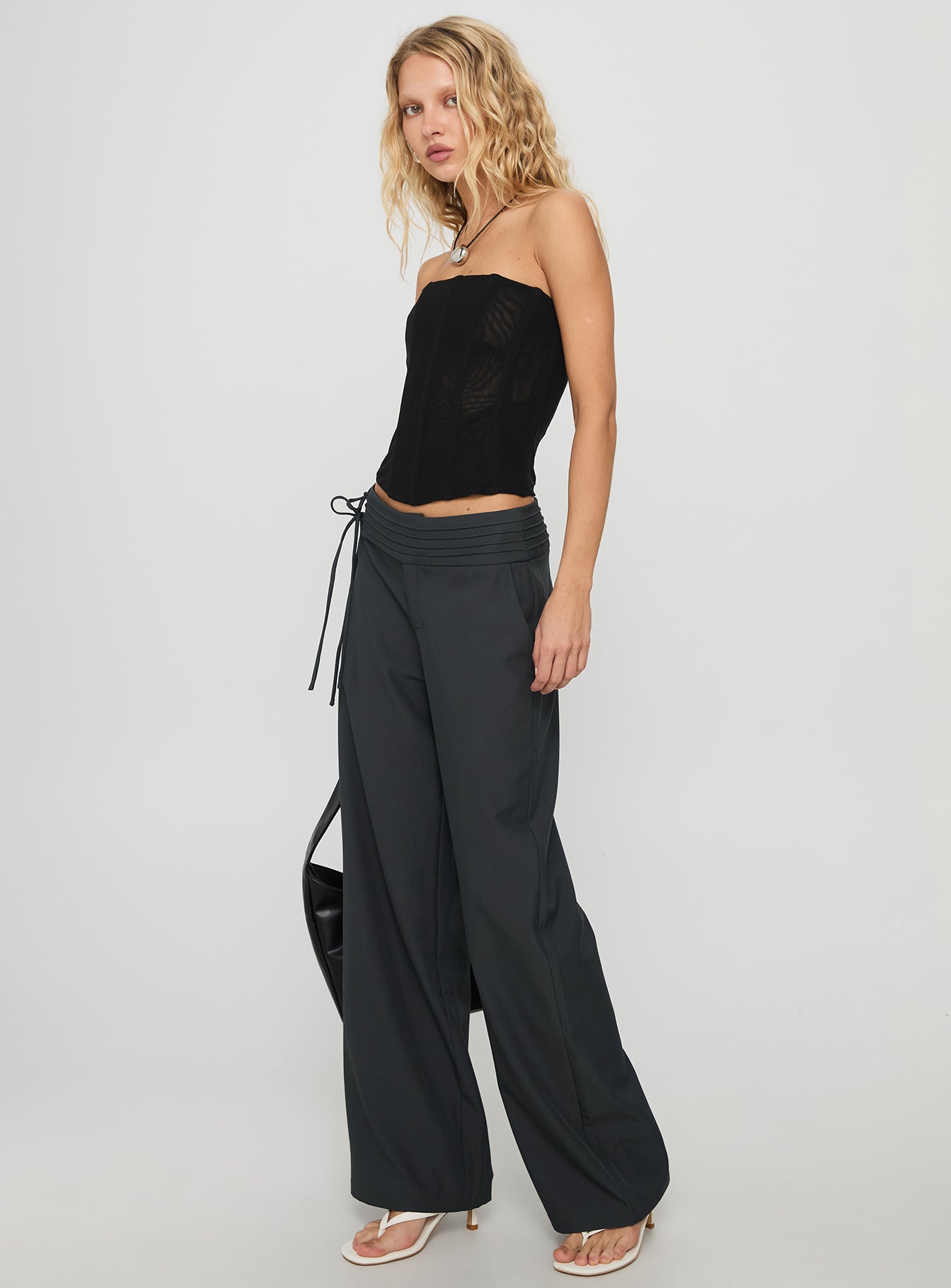 side view of model wearing Princess Polly Good Riddance Pleat Tie Slouch Pants Charcoal Low Rise Pants 