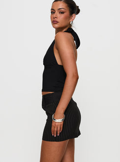   side view of model wearing Princess Polly Christel Pinstripe Skort Black Mini Skirts 