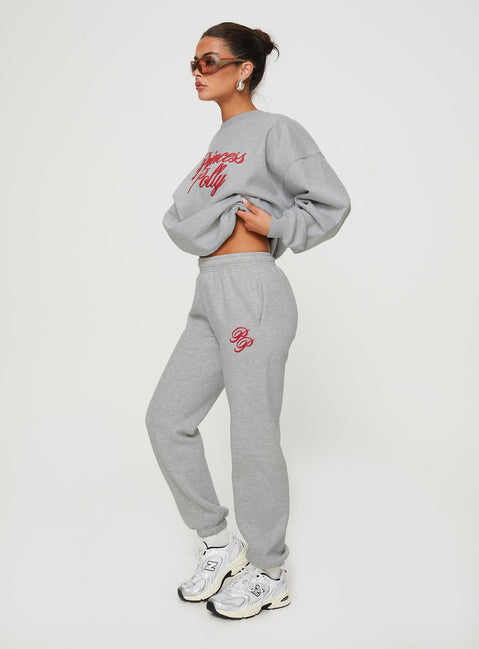 side view of model wearing Princess Polly Princess Polly Track Pants Cursive Text Grey Marle/ Red High Waisted Pants 
