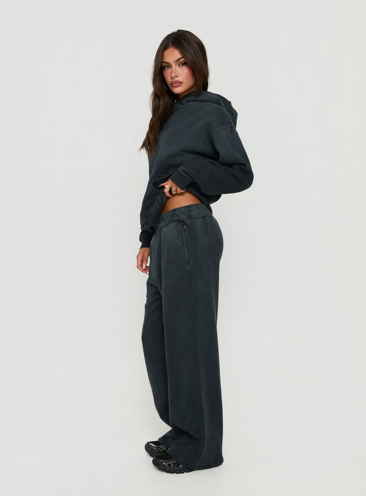 Showcasing black Baggy Sweatpant in womens regular pants with wide-leg mid-rise silhouette side view of model wearing Princess Polly