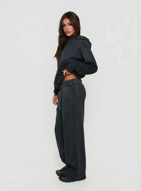 Showcasing black Baggy Sweatpant in womens regular pants with wide-leg mid-rise silhouette side view of model wearing Princess Polly