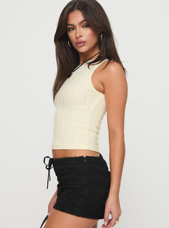 side view of model wearing Princess Polly Dystran Top Cream Sleeveless Crew Neck 