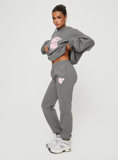 side view of model wearing Princess Polly Princess Polly Track Pants Bubble Text Charcoal / Light Pink Mid Rise 