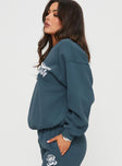 side view of model wearing Princess Polly Princess Polly Crew Neck Sweatshirt Cursive Text Navy / White 