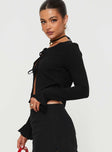 Top Long sleeves with ruffle cuff, sheer material, open front  Tie fastenings at front 