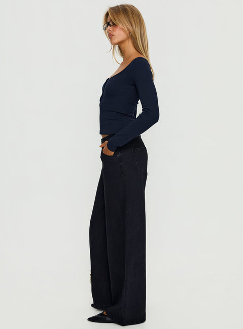 side view of model wearing Princess Polly Supercut Low Rise Baggy Pleat Jeans Washed Black Low Rise Jeans 