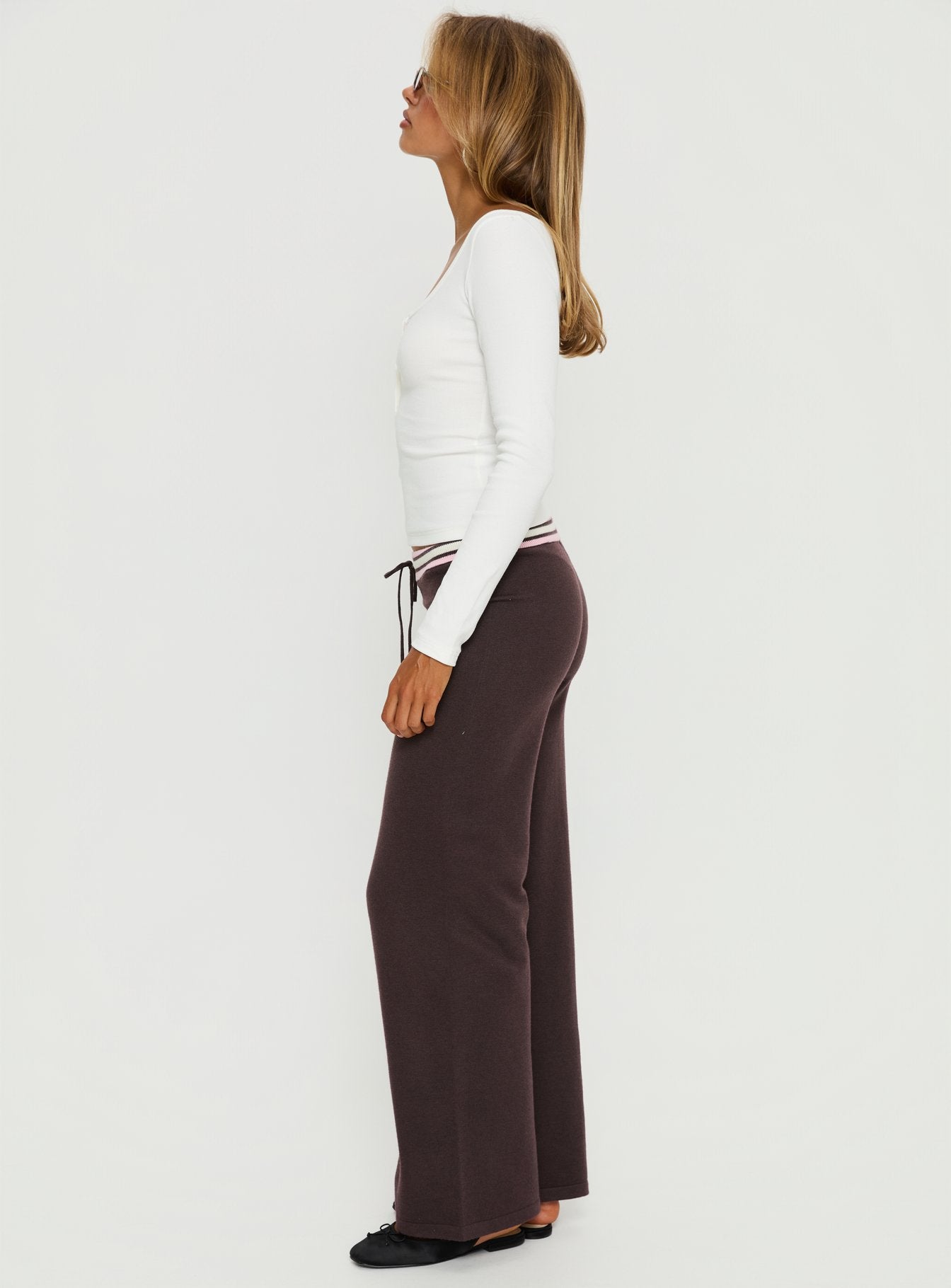 side view of model wearing Princess Polly Felisha Low Waist Knit Pants Brown Low Rise Pants 
