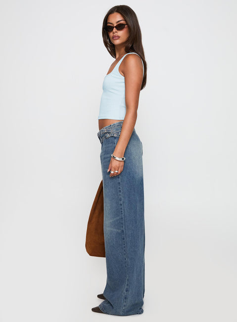 side view of model wearing Princess Polly Paltrow Mid Rise Wide Leg Cargo Jeans Mid Blue Wash Petite Mid Rise Jeans 