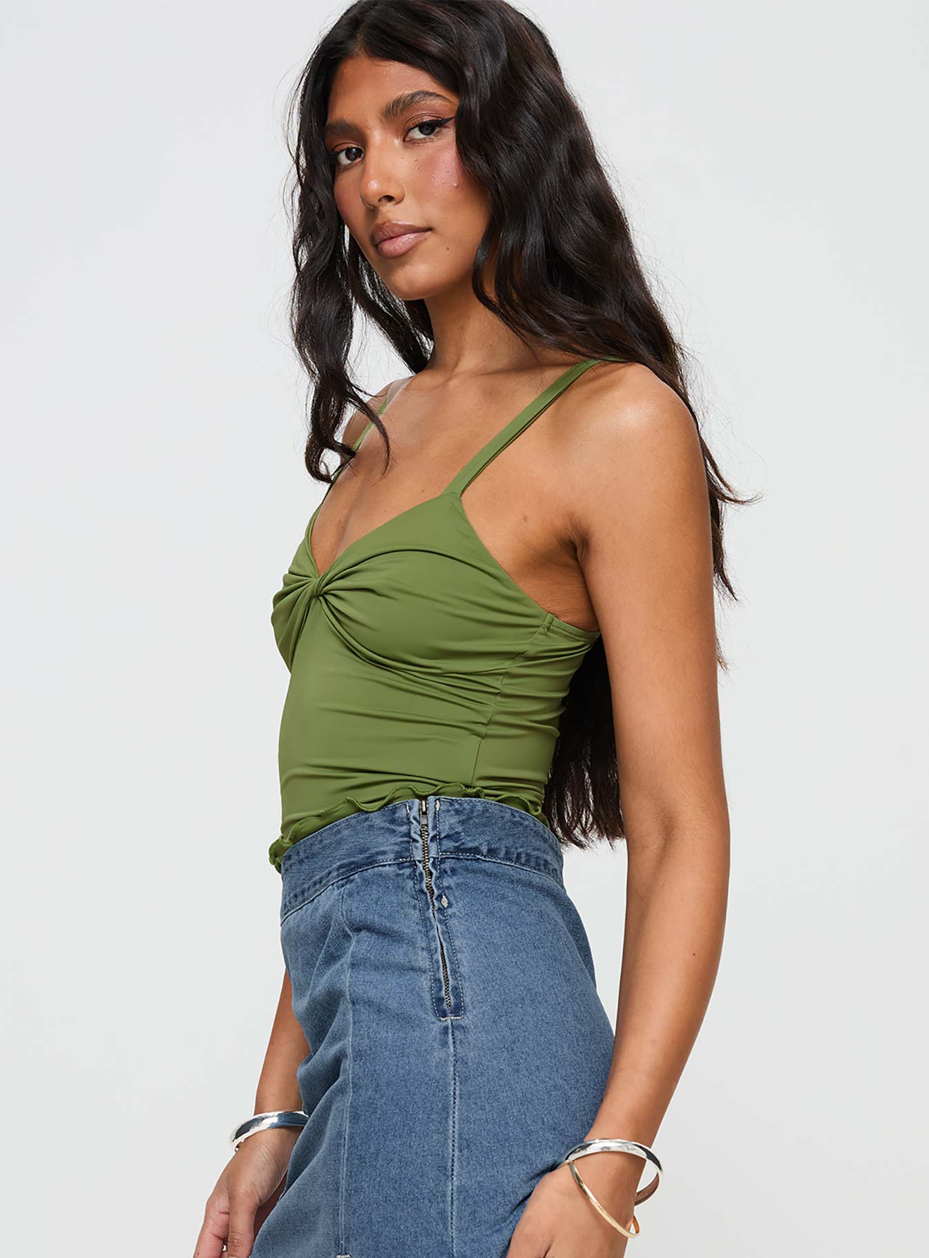 side view of model wearing Princess Polly Greyer Top Green Sleeveless Plunger 