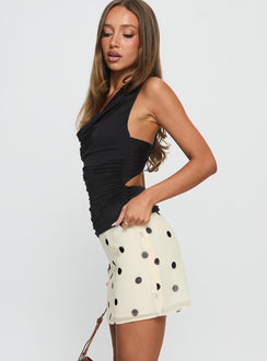   side view of model wearing Princess Polly Adelaida Ruffle Mini Skirt Cream Polka Mini Skirts 