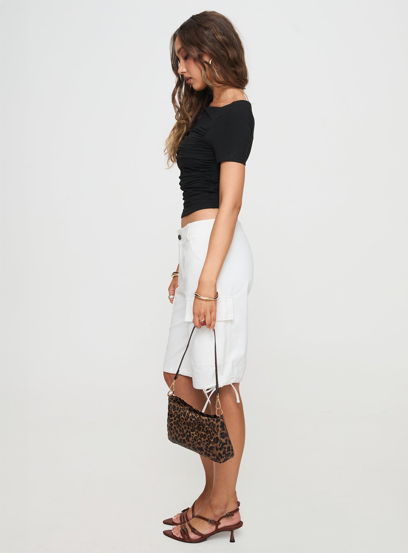 side view of model wearing Princess Polly Bleachers Shorts White High Waisted Shorts 