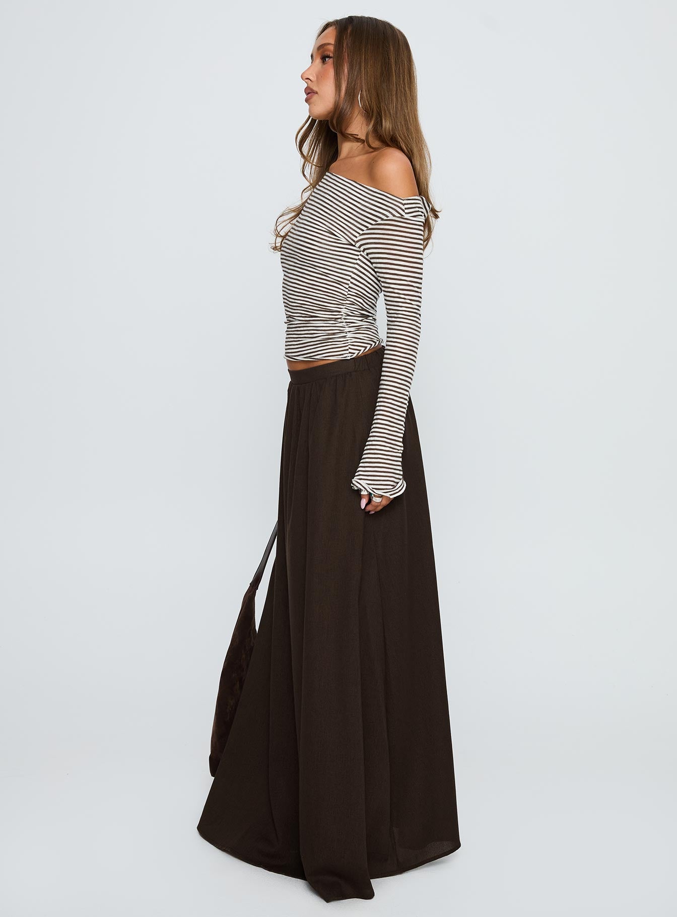   side view of model wearing Princess Polly Hallee Maxi Skirt Brown Maxi 