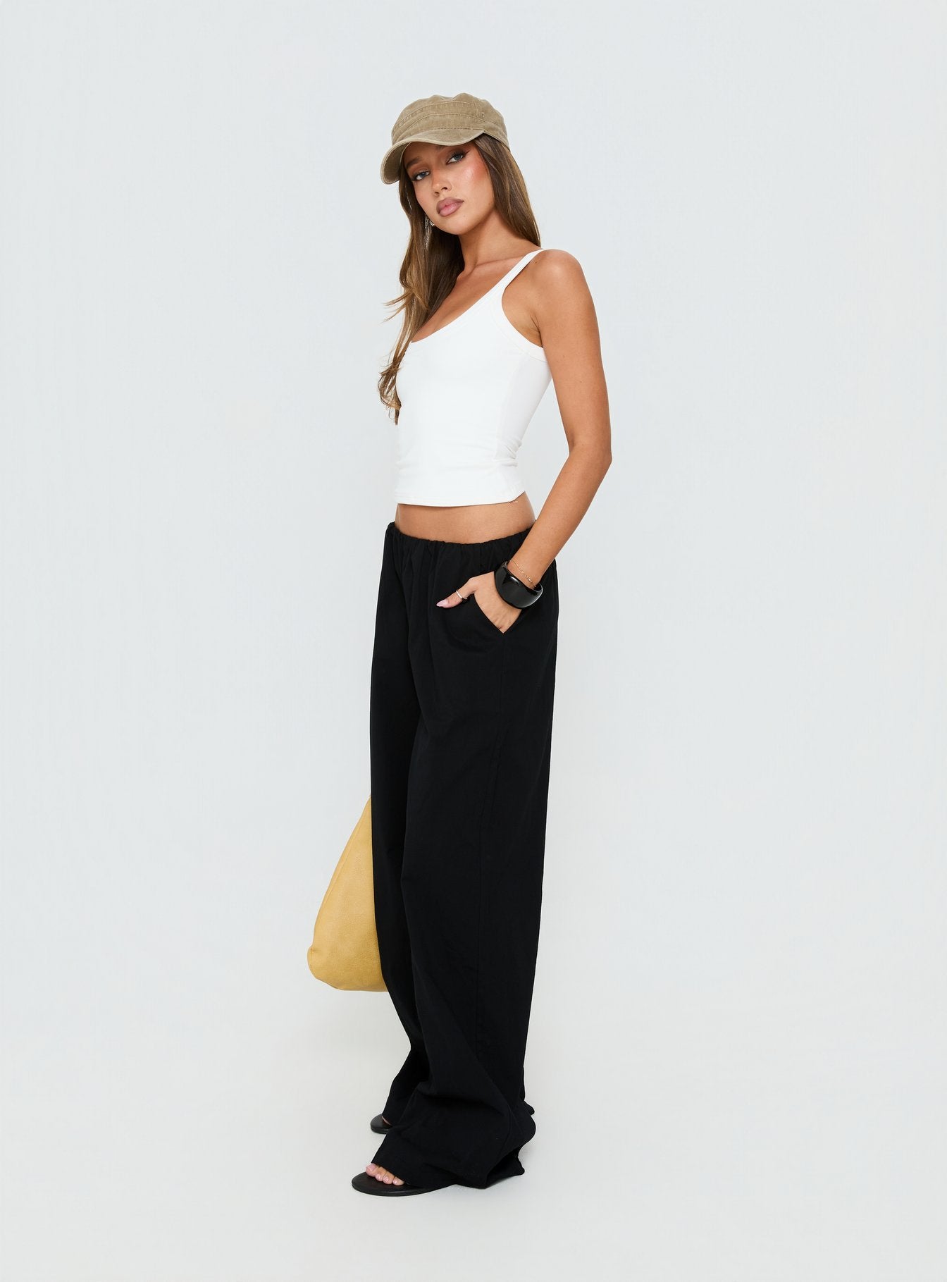 side view of model wearing Princess Polly Lunea Concealed Waistband Pants Black Low Rise Pants 