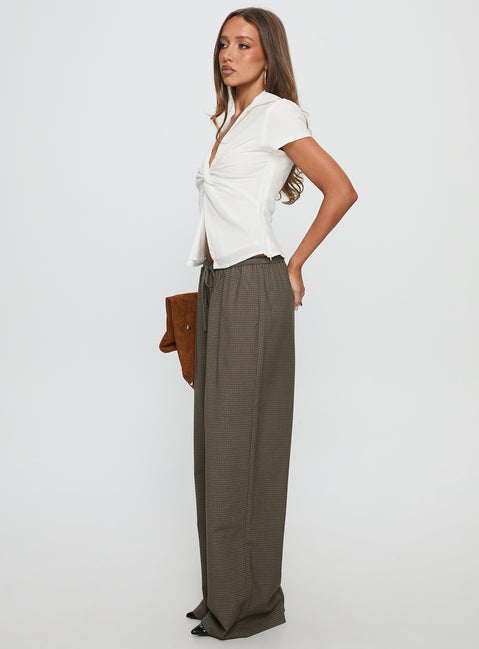 side view of model wearing Princess Polly Ketrina Tie Waist Pants Brown Plaid High Waisted Pants 