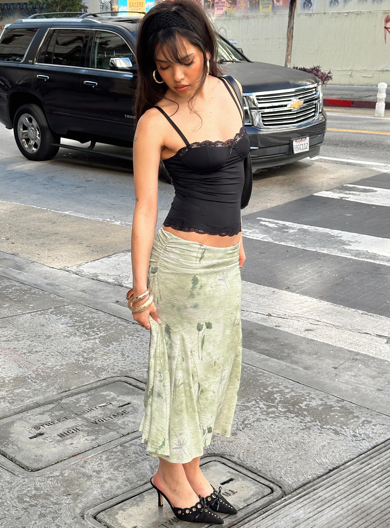   side view of model wearing Princess Polly Lewish Low Rise Midi Skirt Green Floral Midi Skirts 