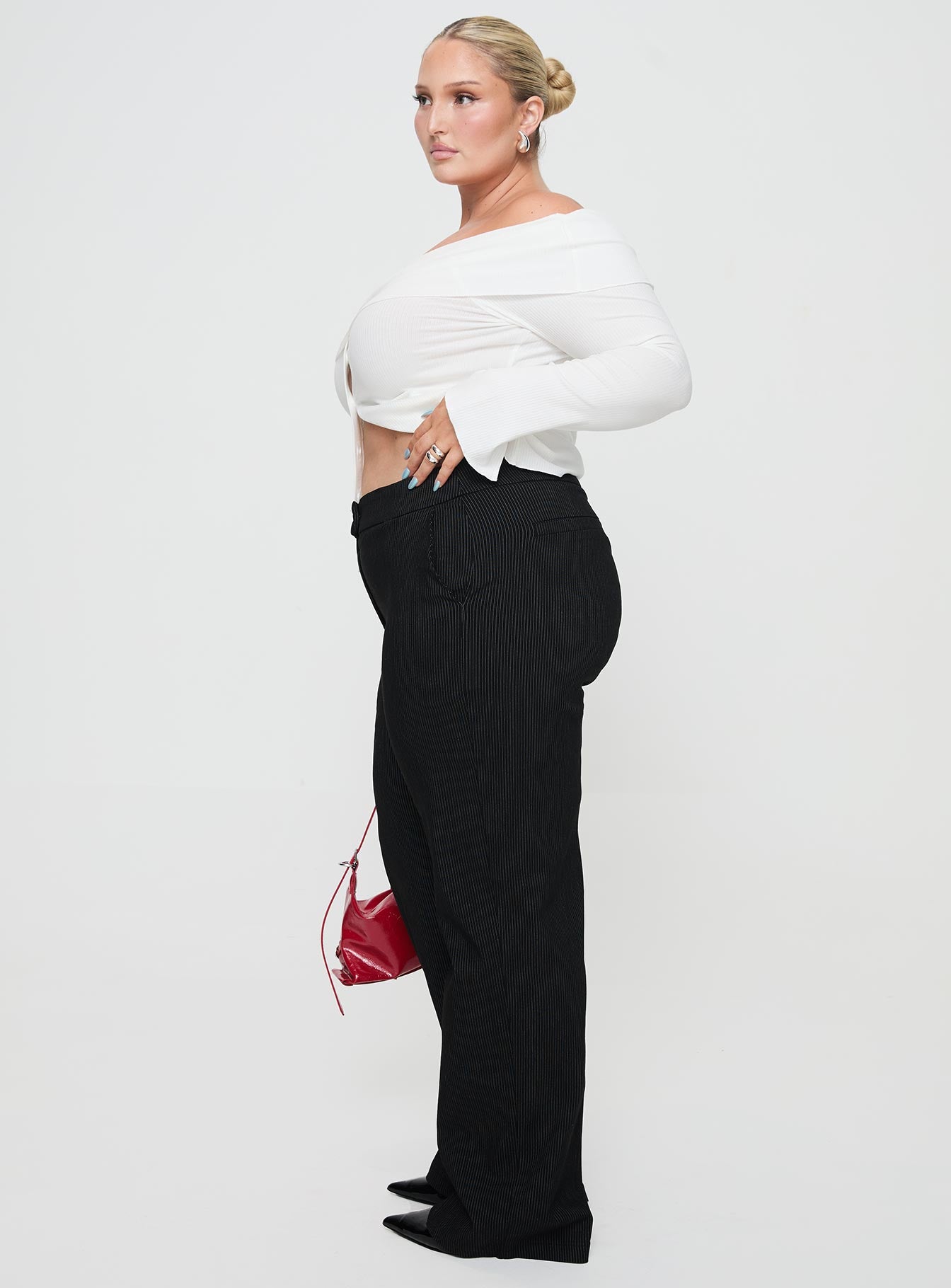 side view of model wearing Princess Polly Jeller Pinstripe Pants Black Curve High Waisted Pants 