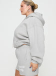 side view of model wearing Princess Polly Princess Polly Hooded Sweatshirt Puff Text Grey Curve 