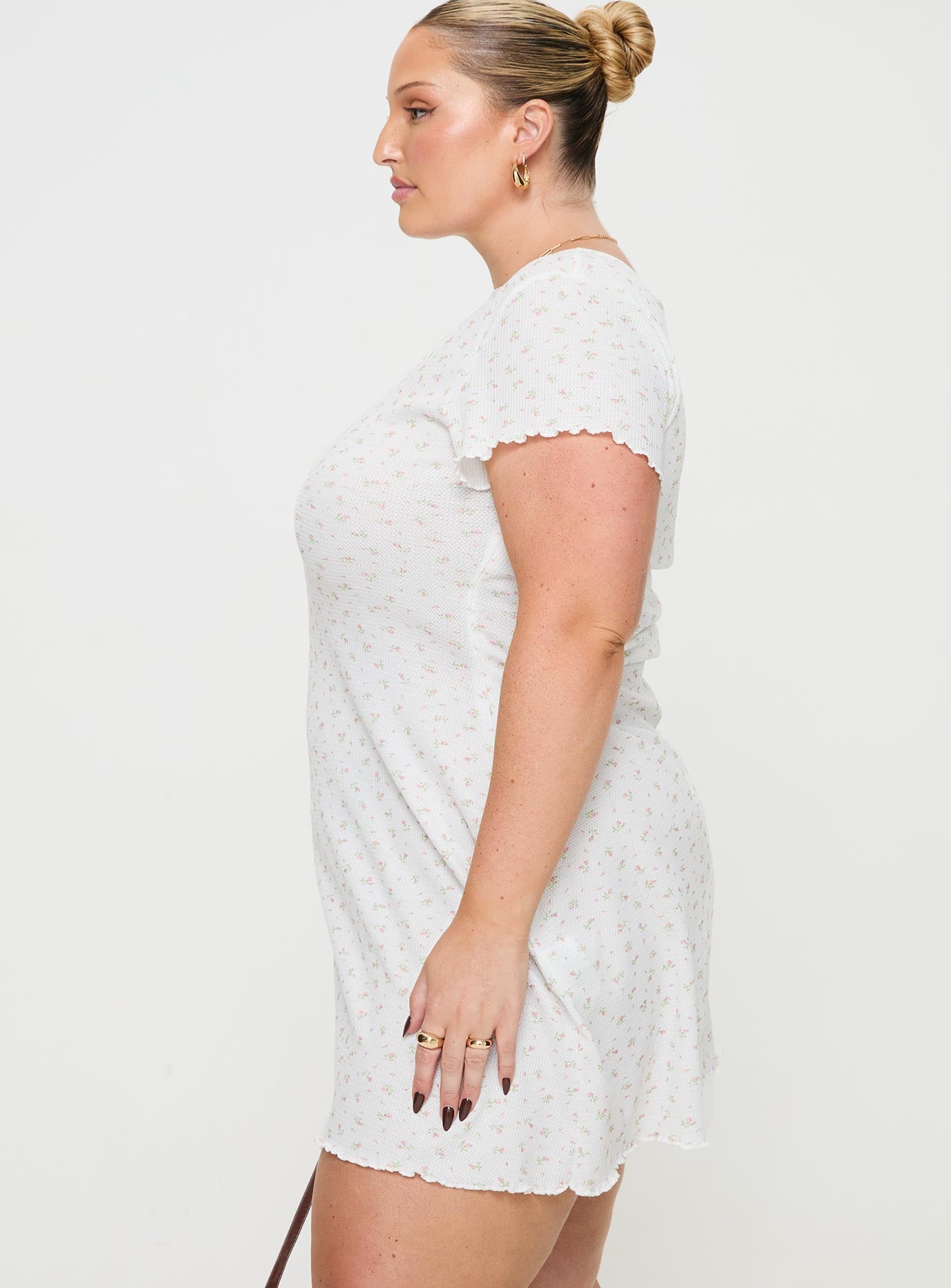side view of model wearing Princess Polly Patton Mini Dress White Floral Curve Crew Neck 