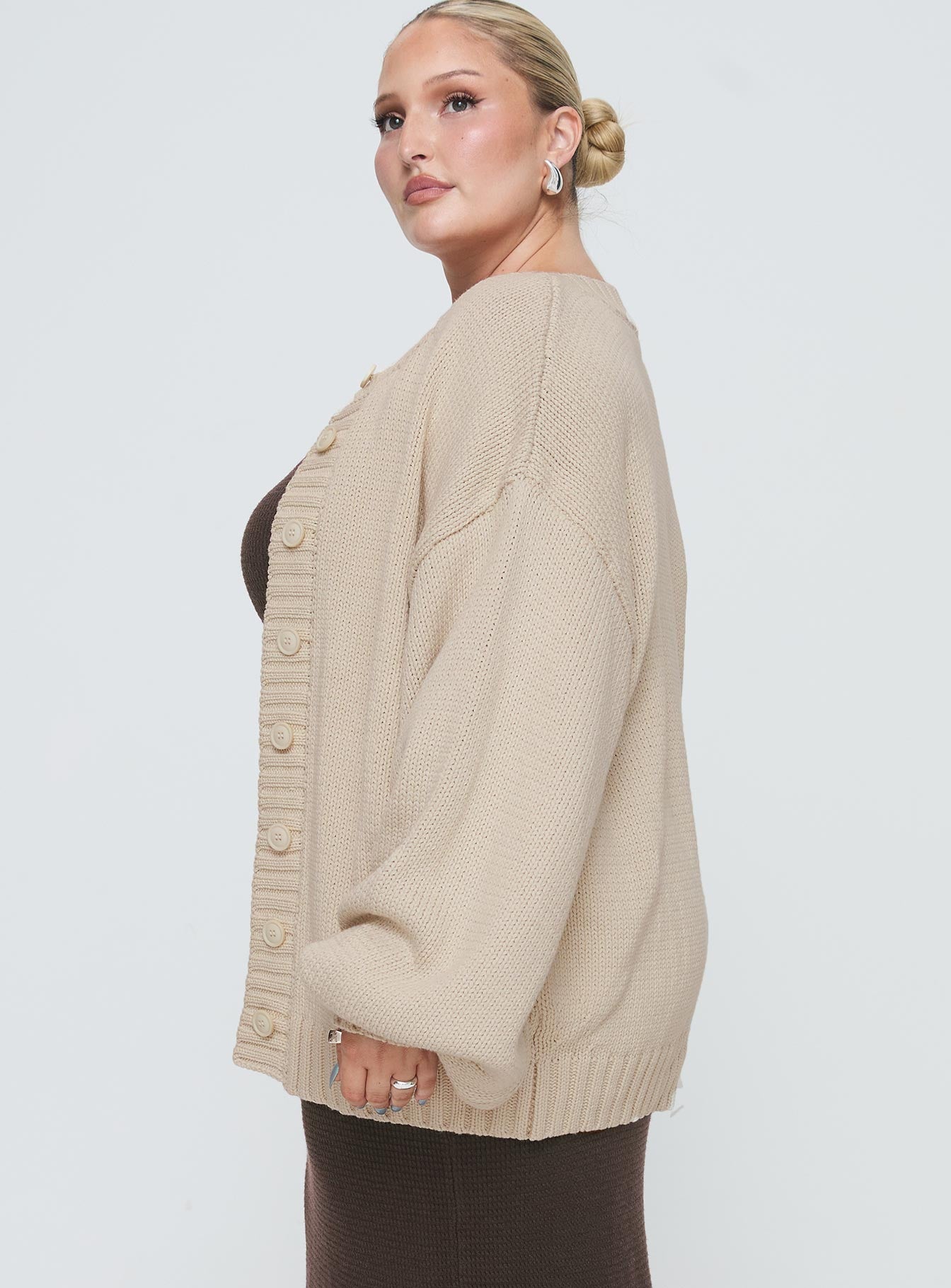 side view of model wearing Princess Polly Edern Cardigan Cream Curve Long 