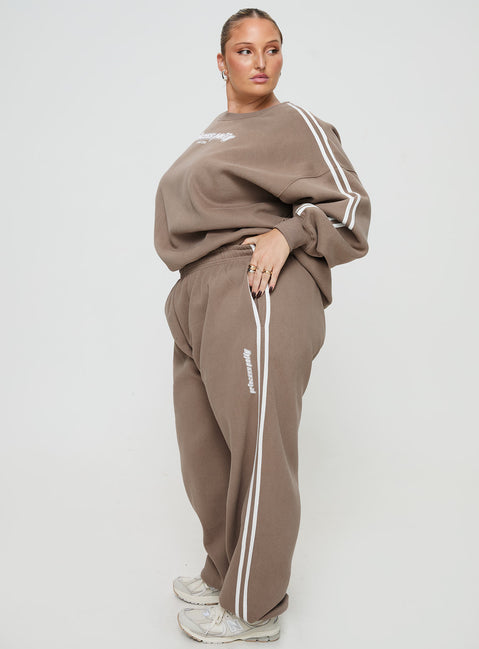 side view of model wearing Princess Polly Princess Polly Track Pants Stripe Taupe / White Curve 