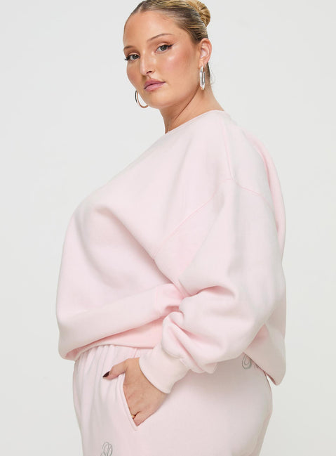 side view of model wearing Princess Polly Princess Polly Crew Neck Sweatshirt Script Baby Pink / Grey Curve 