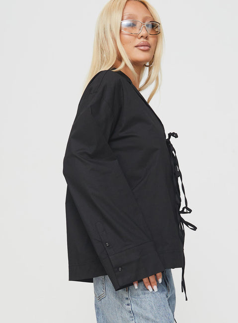 side view of model wearing Princess Polly Spiri Shirt Black Full Sleeves V-Neck 