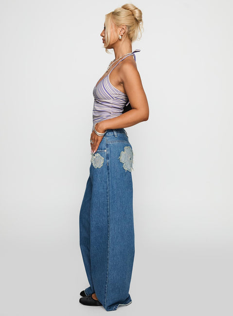 side view of model wearing Princess Polly A Keeper Flower Patch Jeans Mid Blue Low Rise Jeans 