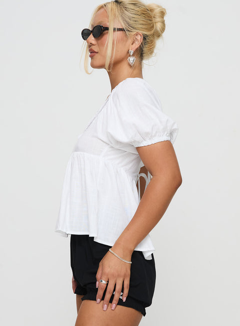 side view of model wearing Princess Polly Weyes Smock Top White Short Sleeves Scoop Neck 