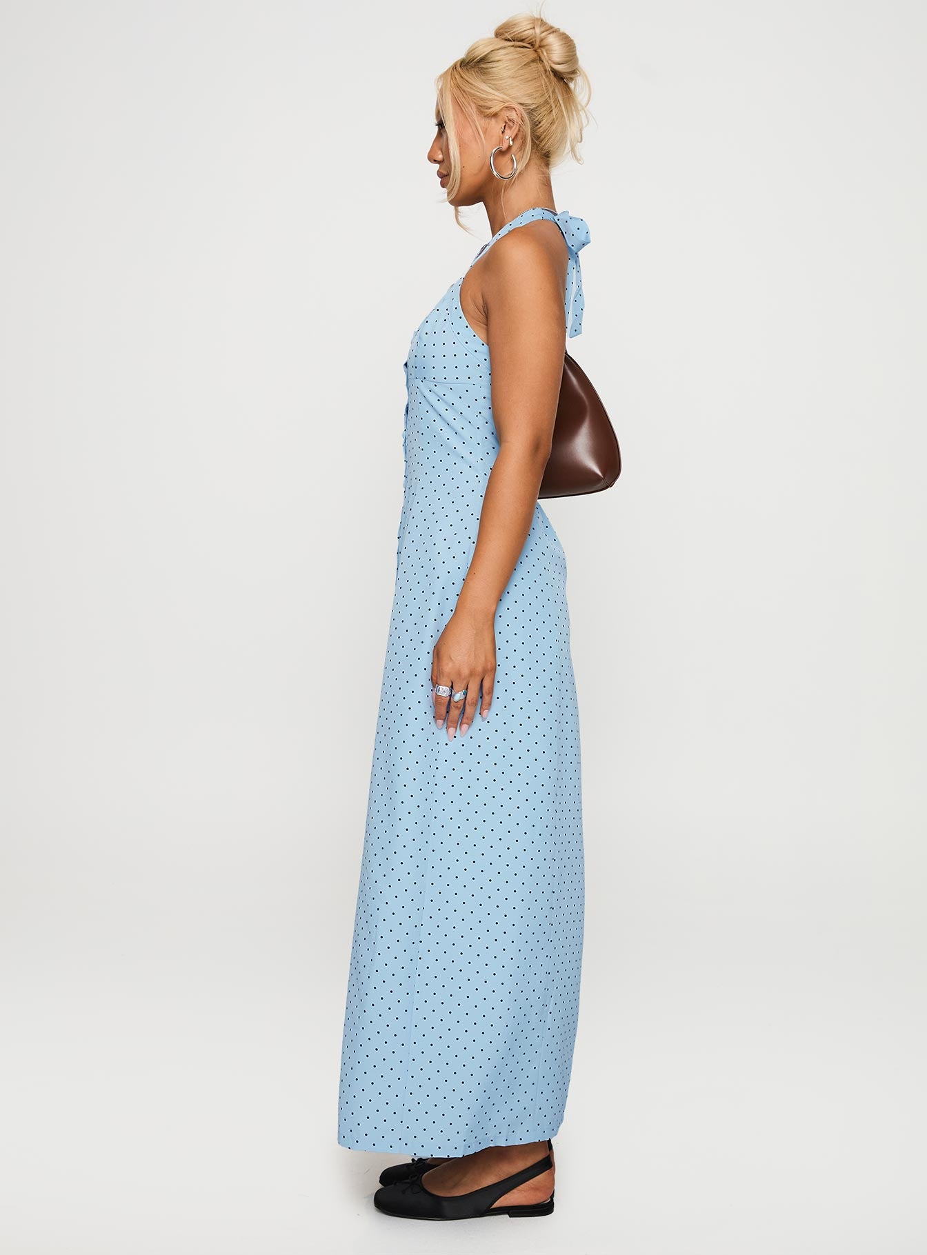 side view of model wearing Princess Polly Mallorie Halter Maxi Dress Blue / Black Polka Scoop Neck 
