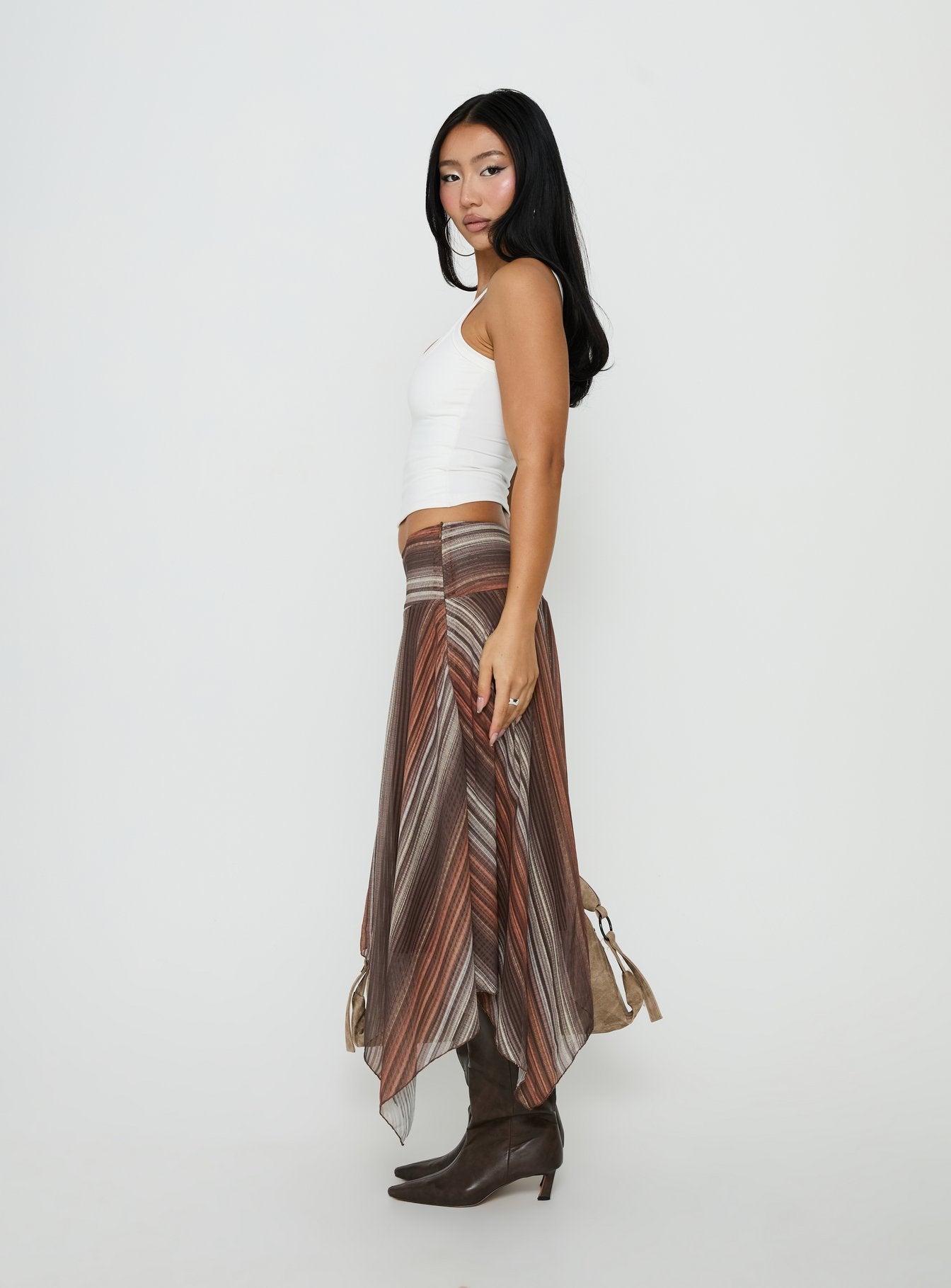 Highlighting the Massino Asymmetrical Midi Skirt Multi Stripe womens-skirts with belt featuring relaxed fit and midi length side view of model wearing Princess Polly