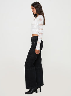 side view of model wearing Princess Polly Adims Jeans Washed Black Mid Rise 