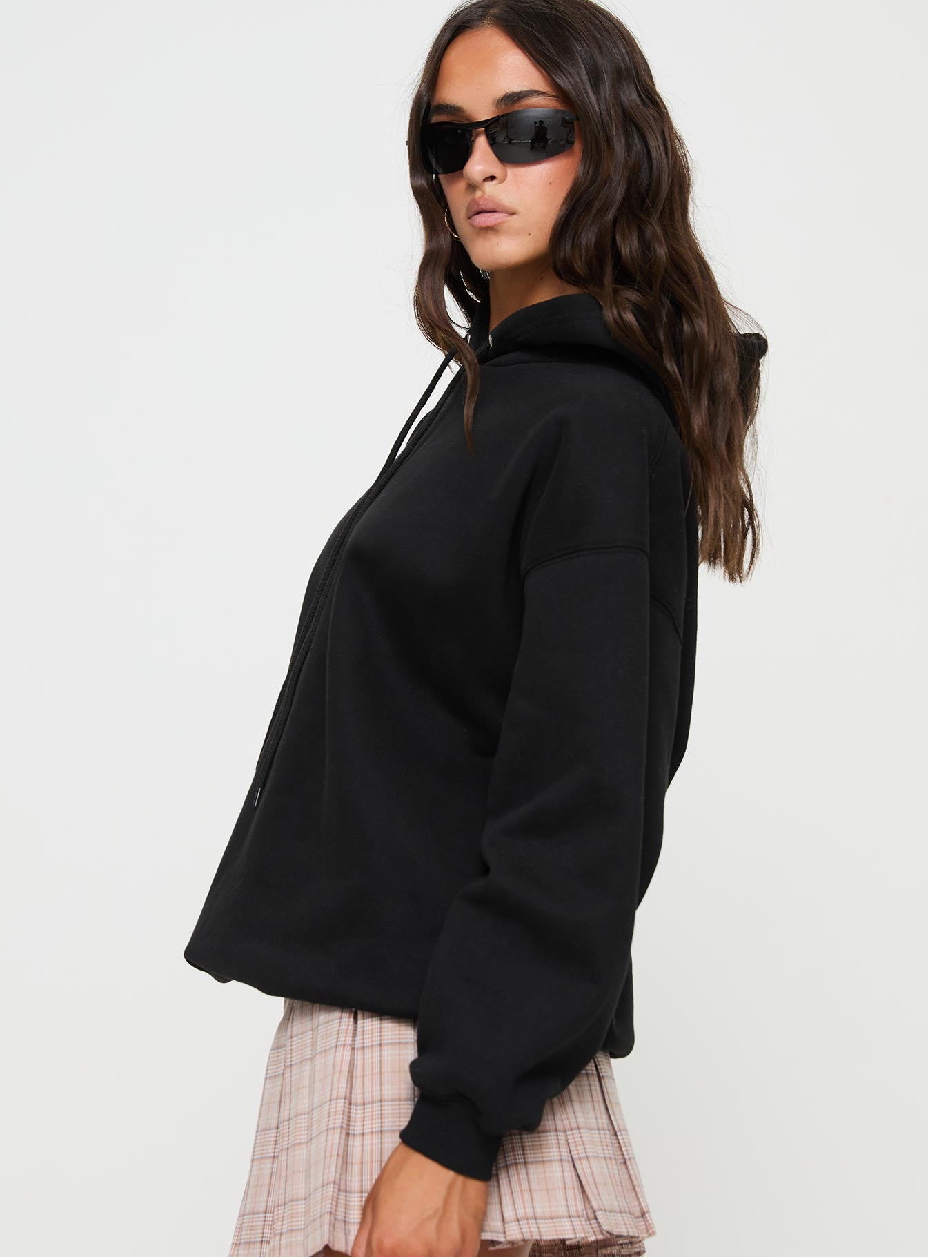 side view of model wearing Princess Polly Alvon Hooded Sweatshirt Black regular 