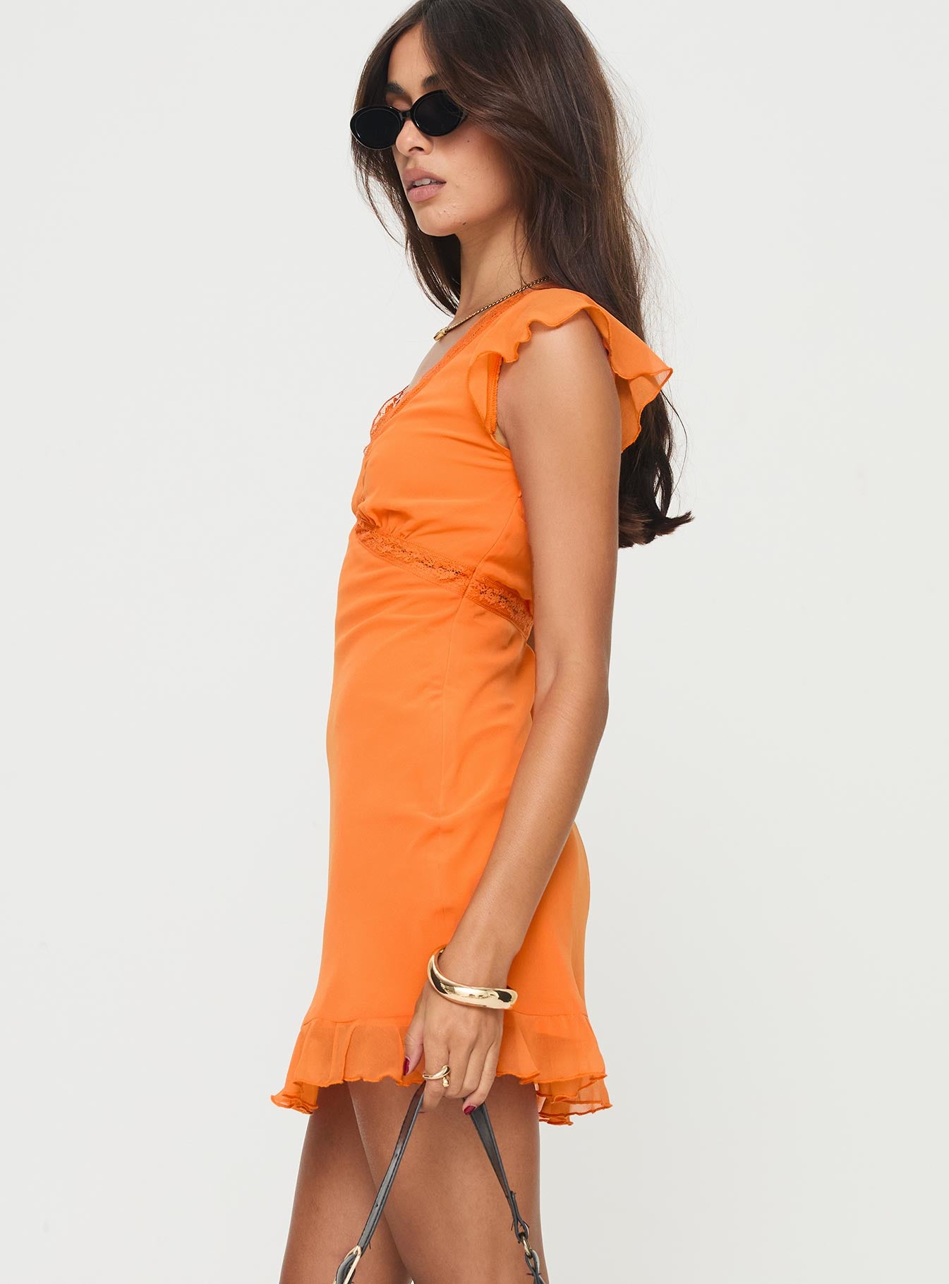 side view of model wearing Princess Polly Barreau Mini Dress Orange V-Neck 