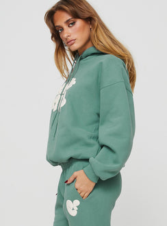 side view of model wearing Princess Polly Princess Polly Hooded Sweatshirt Bubble Text Sage / Eggshell regular 
