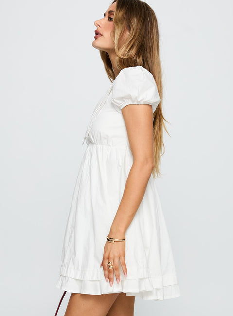 side view of model wearing Princess Polly Sailoh Puff Sleeve Baby Doll Mini Dress White V-Neck 