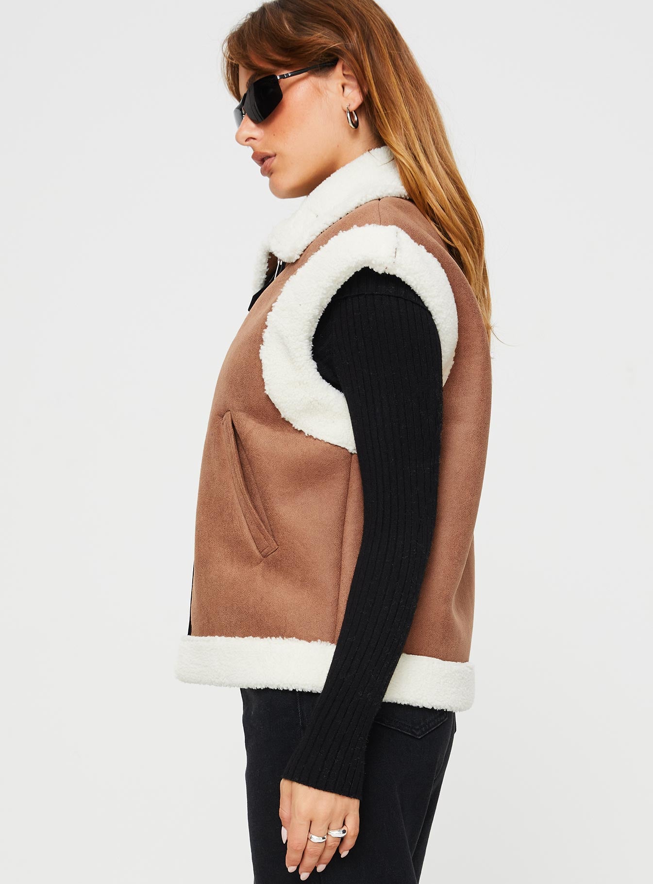 Shearling vest  Classic collar, twin hip pockets, shearling detail at shoulder and hem, faux leather detail and strap fastening at neck, silver-toned hardware, zip fastening at front 