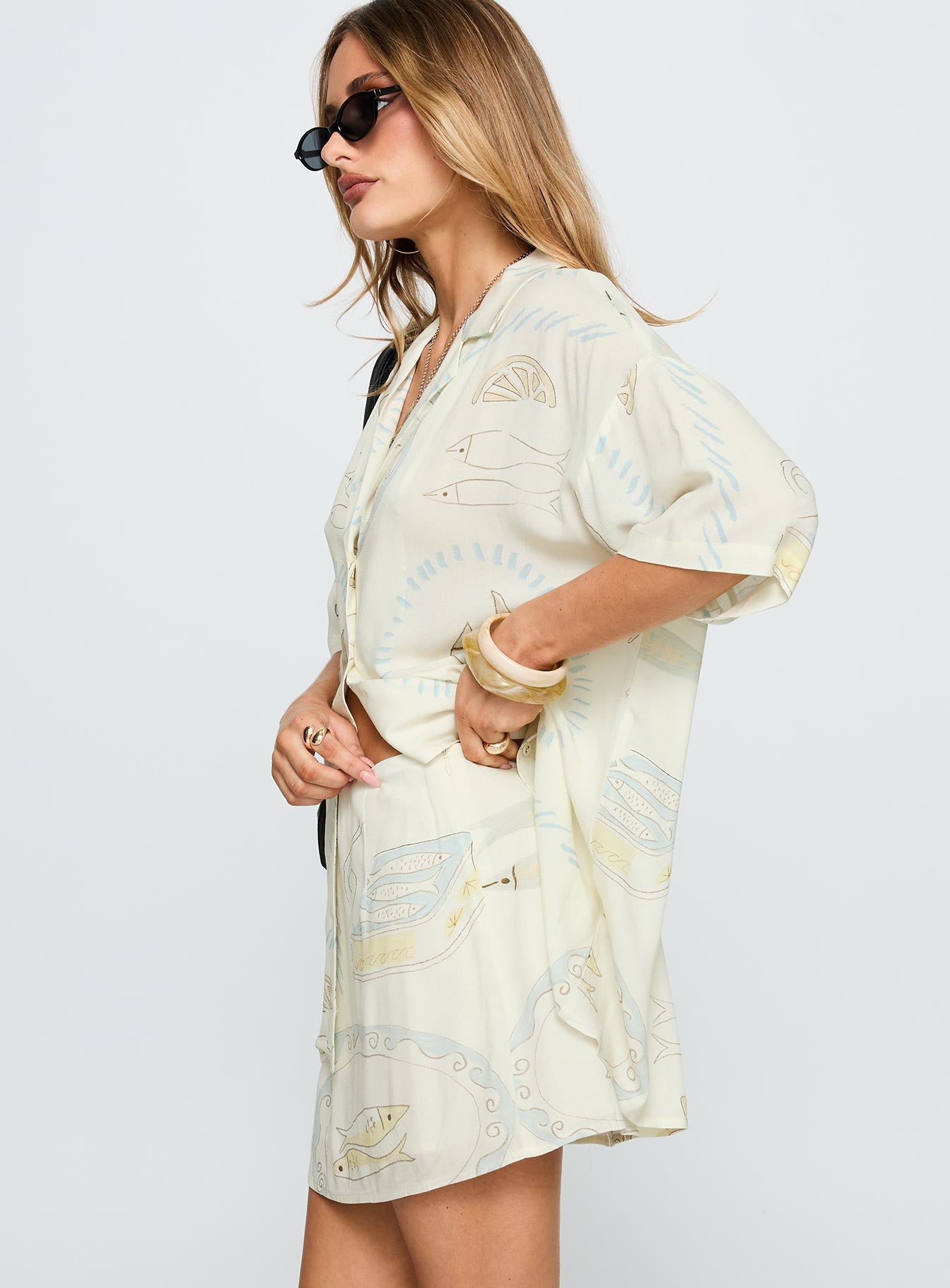   side view of model wearing Princess Polly Caraliia Mini Skirt Cream Mini Skirts 