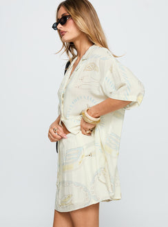   side view of model wearing Princess Polly Caraliia Mini Skirt Cream Mini Skirts 