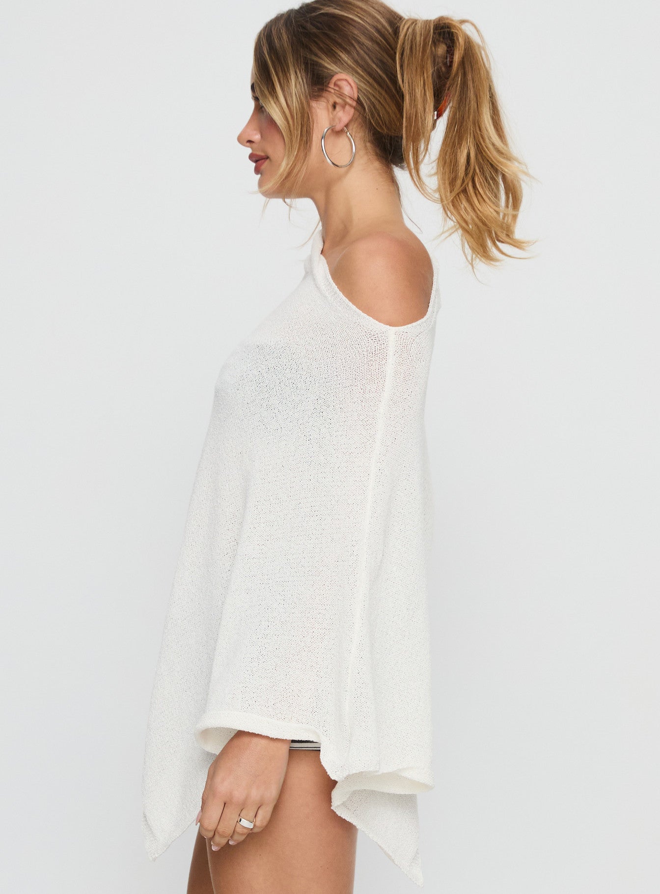side view of model wearing Princess Polly Rouse Off Shoulder Poncho White 