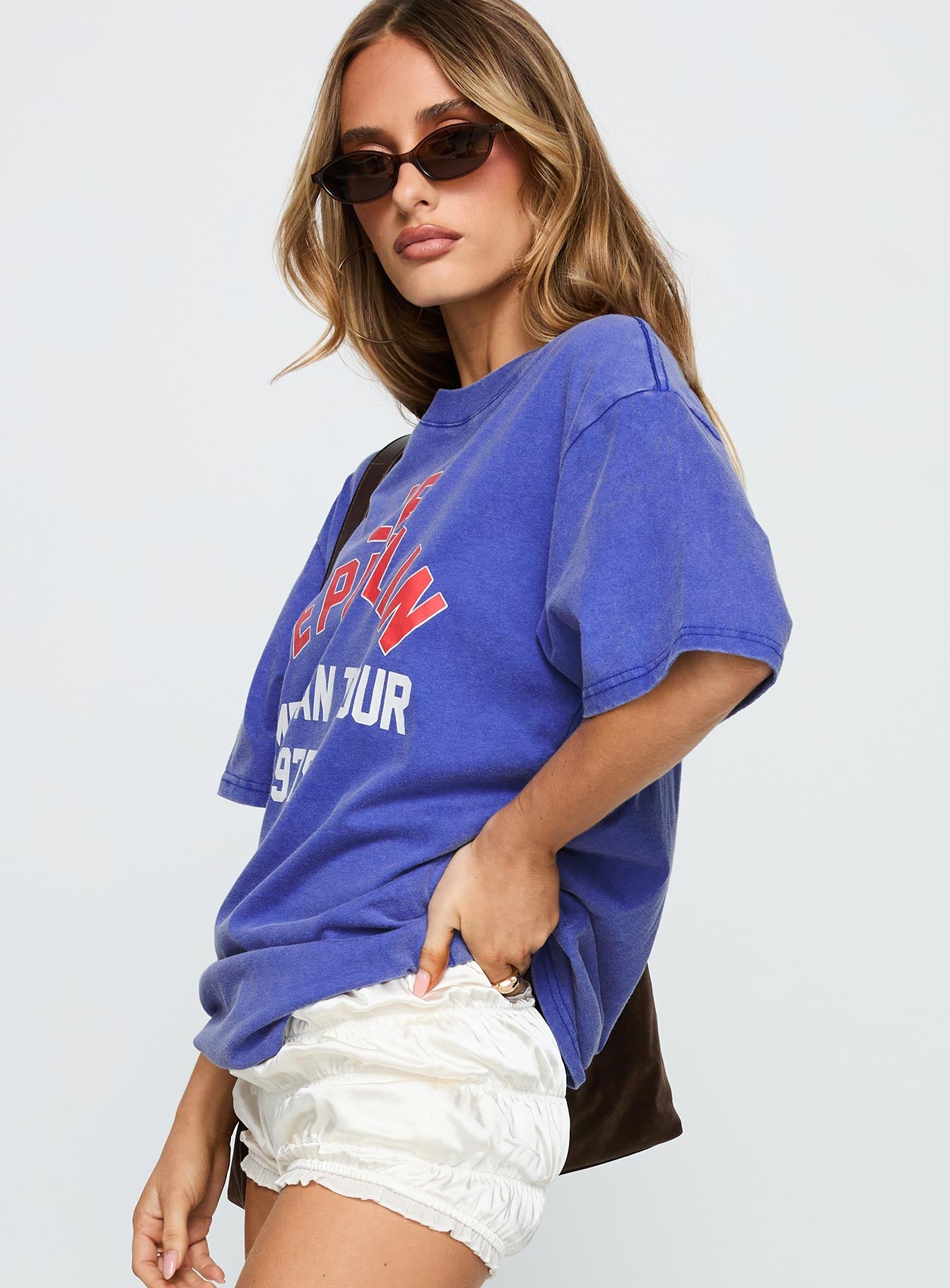 side view of model wearing Princess Polly Led Zeppelin Vintage Oversized Graphic Tee Blue Half Sleeves Crew Neck 