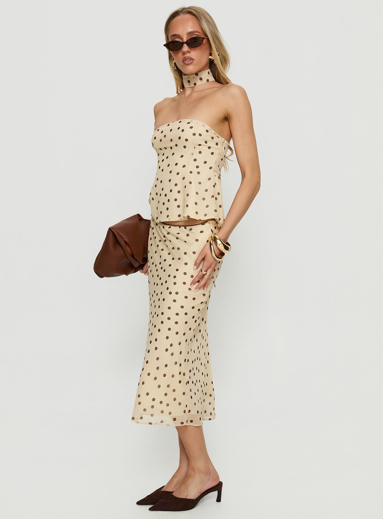   side view of model wearing Princess Polly Sydni Midi Bias Cut Skirt Yellow / Chocolate Polka Midi Skirts 