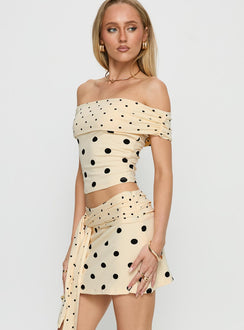   side view of model wearing Princess Polly Porzia Wrap Detail Mini Skirt Cream / Polka Dot Mini Skirts 