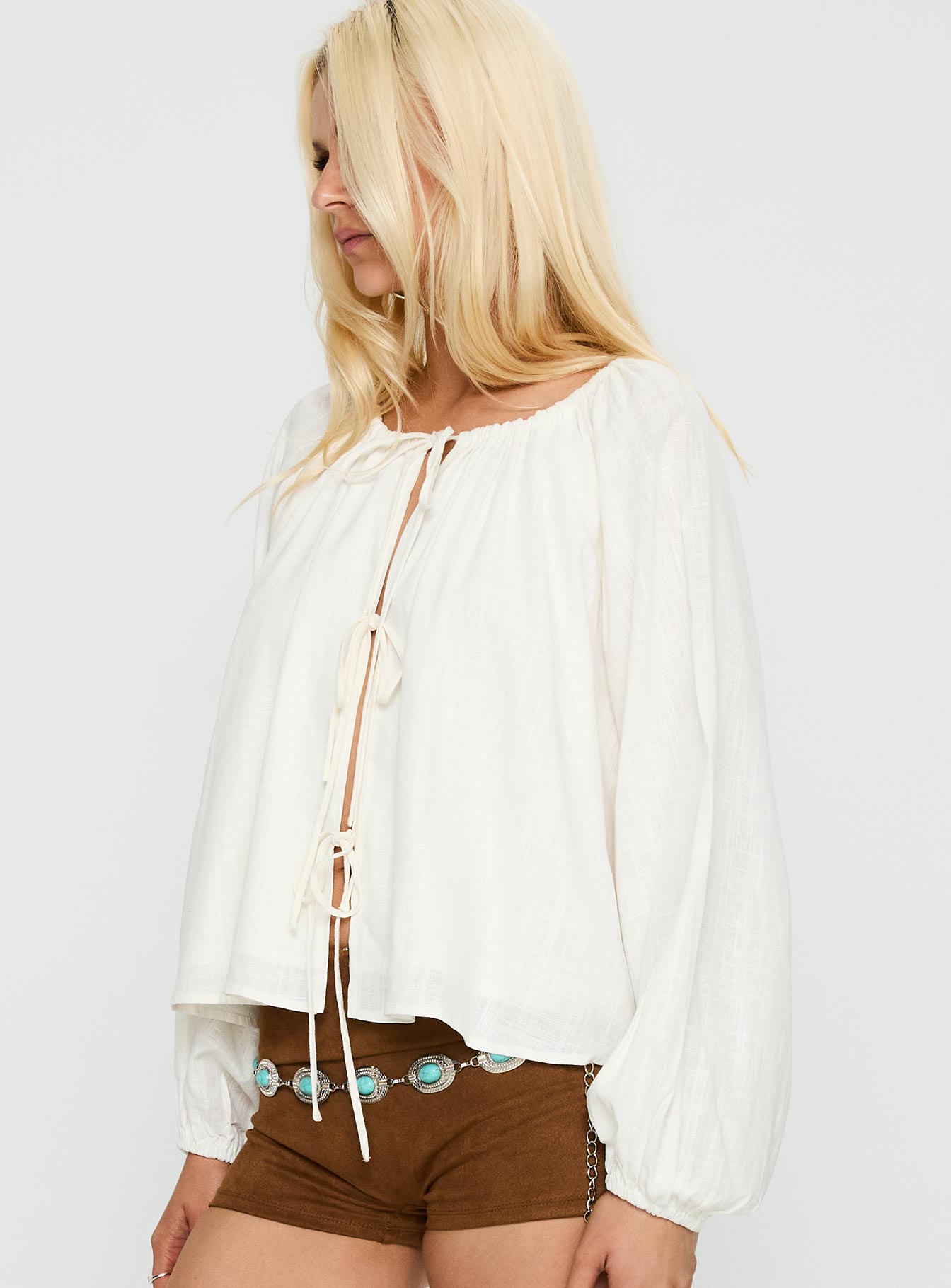 side view of model wearing Princess Polly Somebody Else Tie Up Top White Full Sleeves Crew Neck 