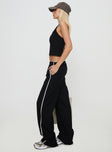 side view of model wearing Princess Polly Doors Open Pant Black Low Rise Pants 