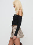 side view of model wearing Princess Polly Korren Low Rise Skort Plaid Tall 