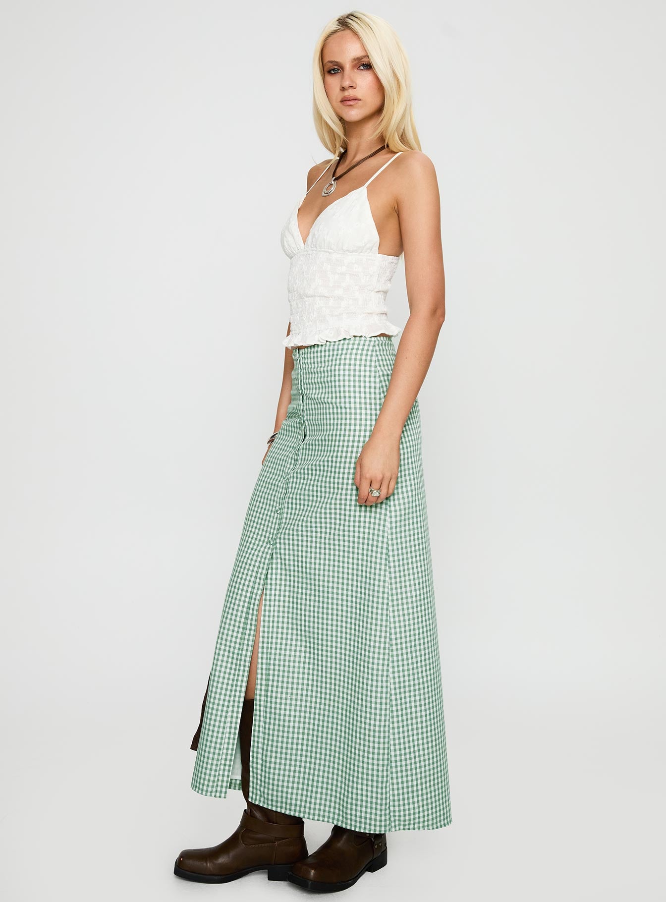   side view of model wearing Princess Polly Macadamia Maxi Skirt Green / White Maxi 